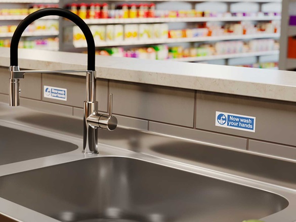 Blue on white waterproof P-touch TZe labels near sink to remind staff to wash their hands